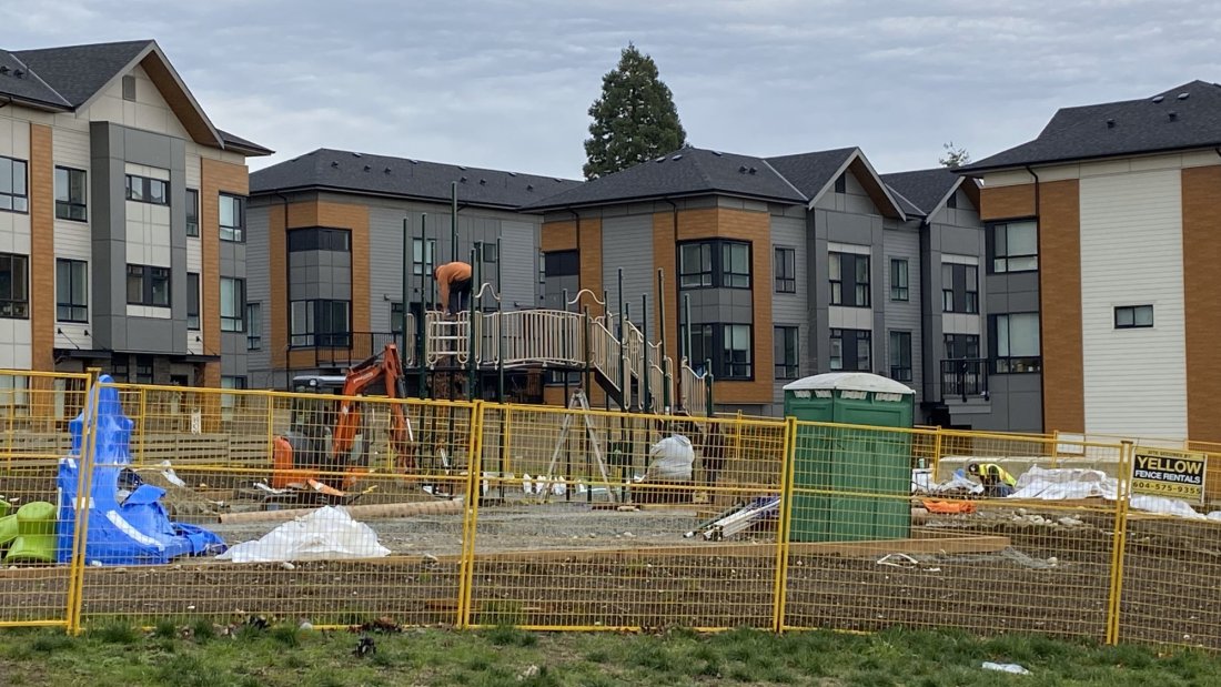 park under construction with townhomes in background