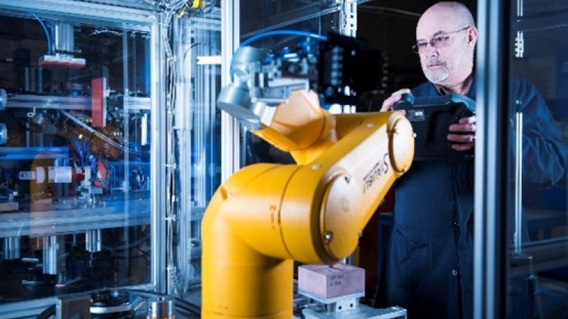 a man works on industrial equipment