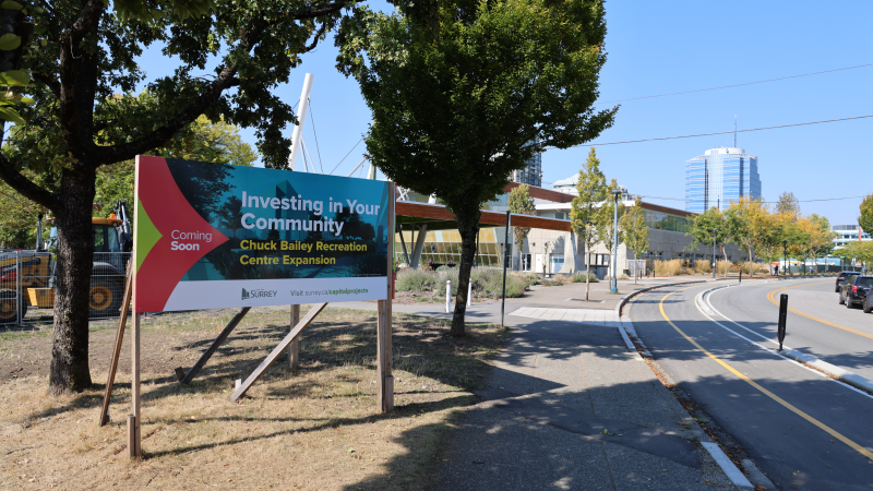 sign in front of recreation centre that reads "coming soon investing in your community: chuck bailey recreation centre expansion"