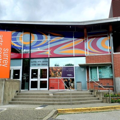 Entrance to Surrey Art Gallery and Surrey Arts Centre showing a colourful vinyl window mural.