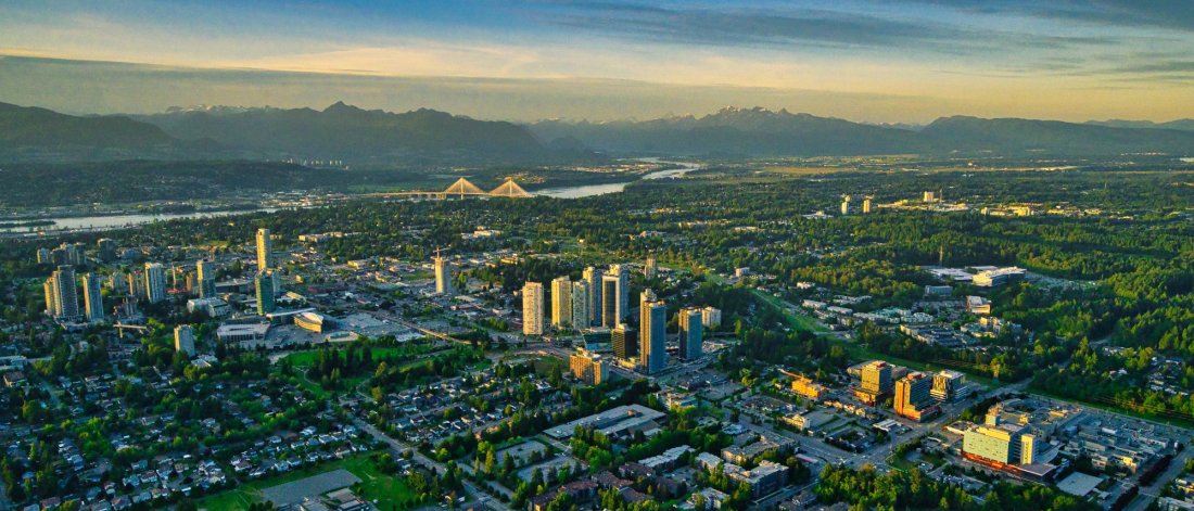 An aerial of Surrey with clouds, mountains and sunshine