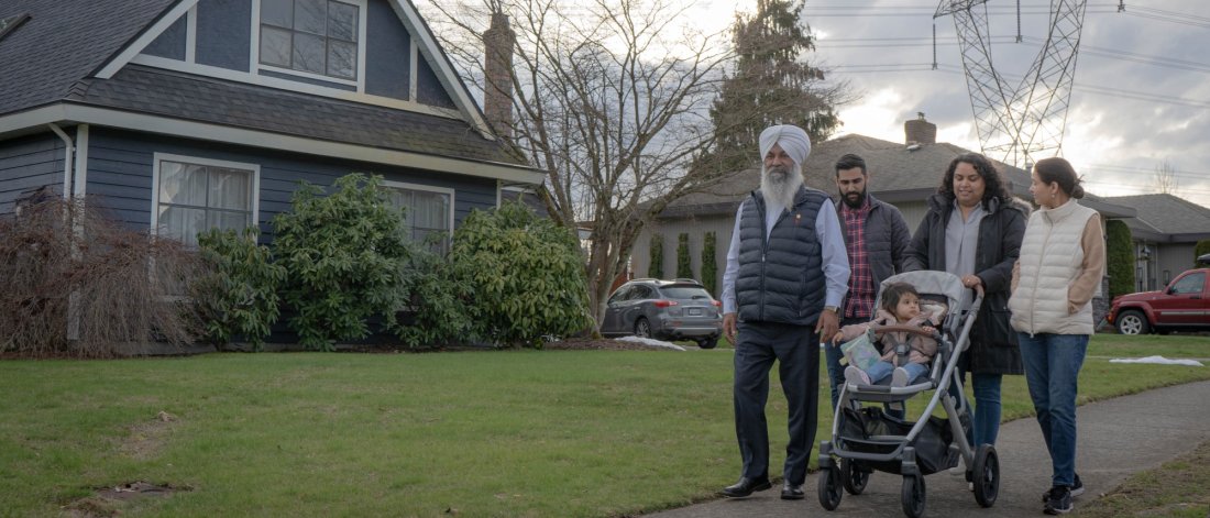 multigenerational family walking along sidewalk