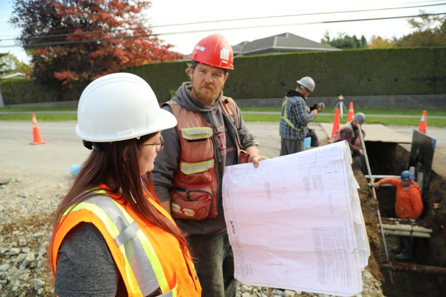 man and woman looking at building plans