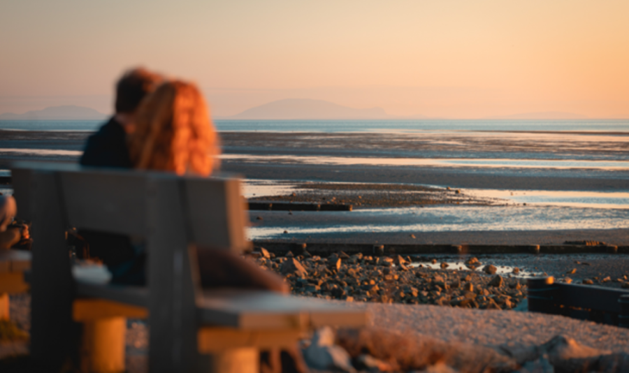 Crescent Beachgoers on a bench and dusk